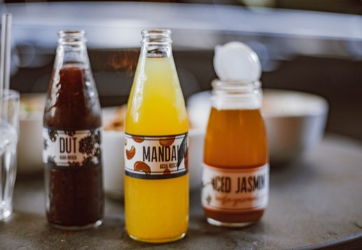 Beverage bottles with clear no-label-look labels